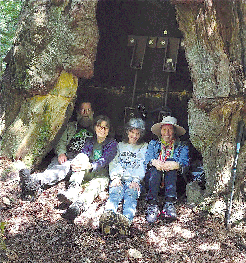 Pictured at the base of Luna from left to right: Sanctuary Forest Board Members Stuart Moskowitz and Janice Parakilas, and Women Forest Sanctuary members 
Susan Werner and Robin.  photo by Susan Parsons