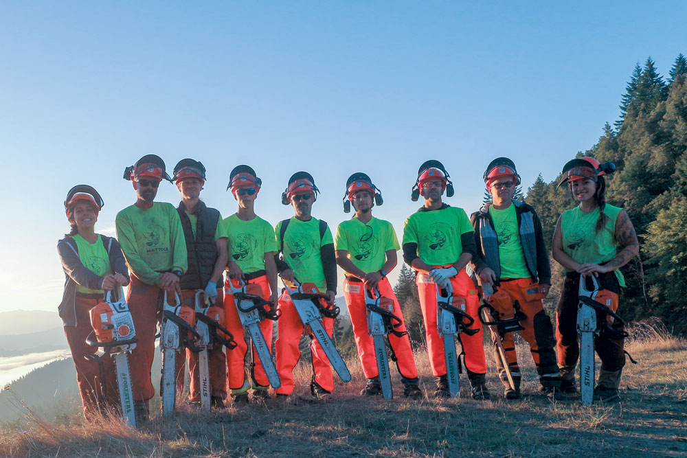 MRC Saw Crew poses for photo on their first official day at the Chapman Ranch. The crew will later perform falling operations in Sudden Oak Death territory on steep slopes to start repairing the damage done by the Canoe Fire, 2003. (From left to right: Shira Brown, Samuel Keener, David Liming, Wyatt Leach, Bill Leach, Miles Oliart, Liam McPhee, Sam Epperson, Jordan Anderson).  Photo by Eleonore J. Anderson